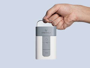 Hand holding the ETENWOLF AIR 5 showing its compact size and integrated metal hanging hook for easy carrying.