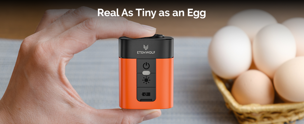 Handheld ETENWOLF Air 3 orange mini electric air pump compared with real eggs to show its pocket size