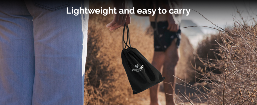 Handheld ETENWOLF Air 3 electric air pump inside its black drawstring storage bag during an outdoor travel trip