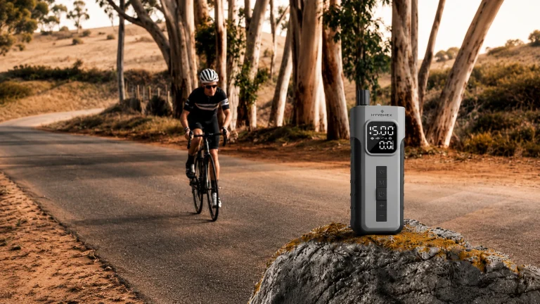 ETENWOLF C2 portable tire inflator displayed beside a cyclist on a countryside road