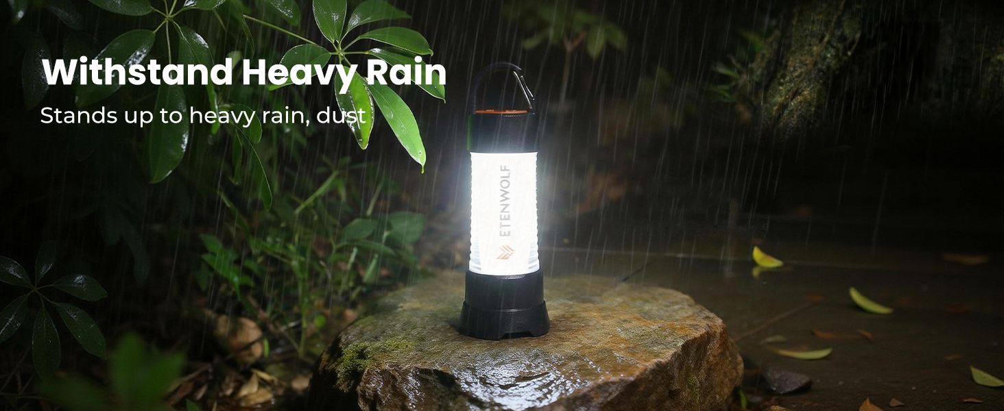 ETENWOLF CL5 camping lantern standing up to heavy rain and dust on a wet rock, showcasing its IPX5 waterproof rating.