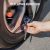 Using ETENWOLF G101 pencil tire gauge to deflate car tire pressure on the road.