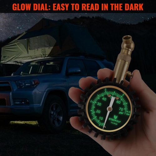 ETENWOLF G200 tire gauge with glow-in-the-dark dial being used at night during camping.