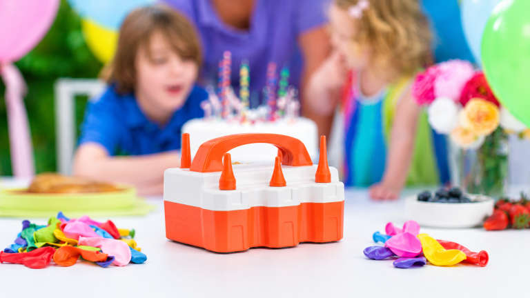 ETENWOLF P600 electric balloon pump placed at the center of a birthday party table with colorful balloons and party decorations