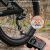 ETENWOLF S0 palm-size electric bike pump inflating a bicycle tire in 20 seconds, reaching up to 10.35 bar (150 PSI).