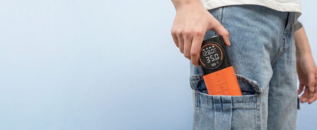Showing ETENWOLF S1 inflator being easily tucked into a pocket, highlighting its compact industrial design