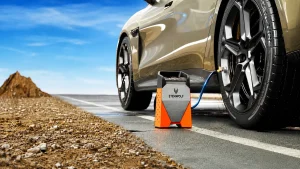 ETENWOLF S3 portable tire inflator connected to an SUV tire on an open road