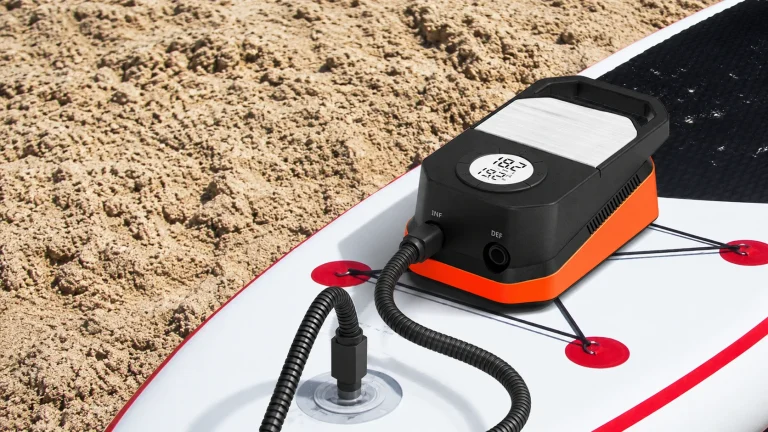 ETENWOLF S4 portable SUP pump connected to an inflatable paddle board on the beach