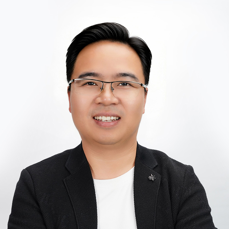 Man with glasses in a gray t-shirt, professional corporate headshot of Wayne Zhang, CEO and Co-founder.
