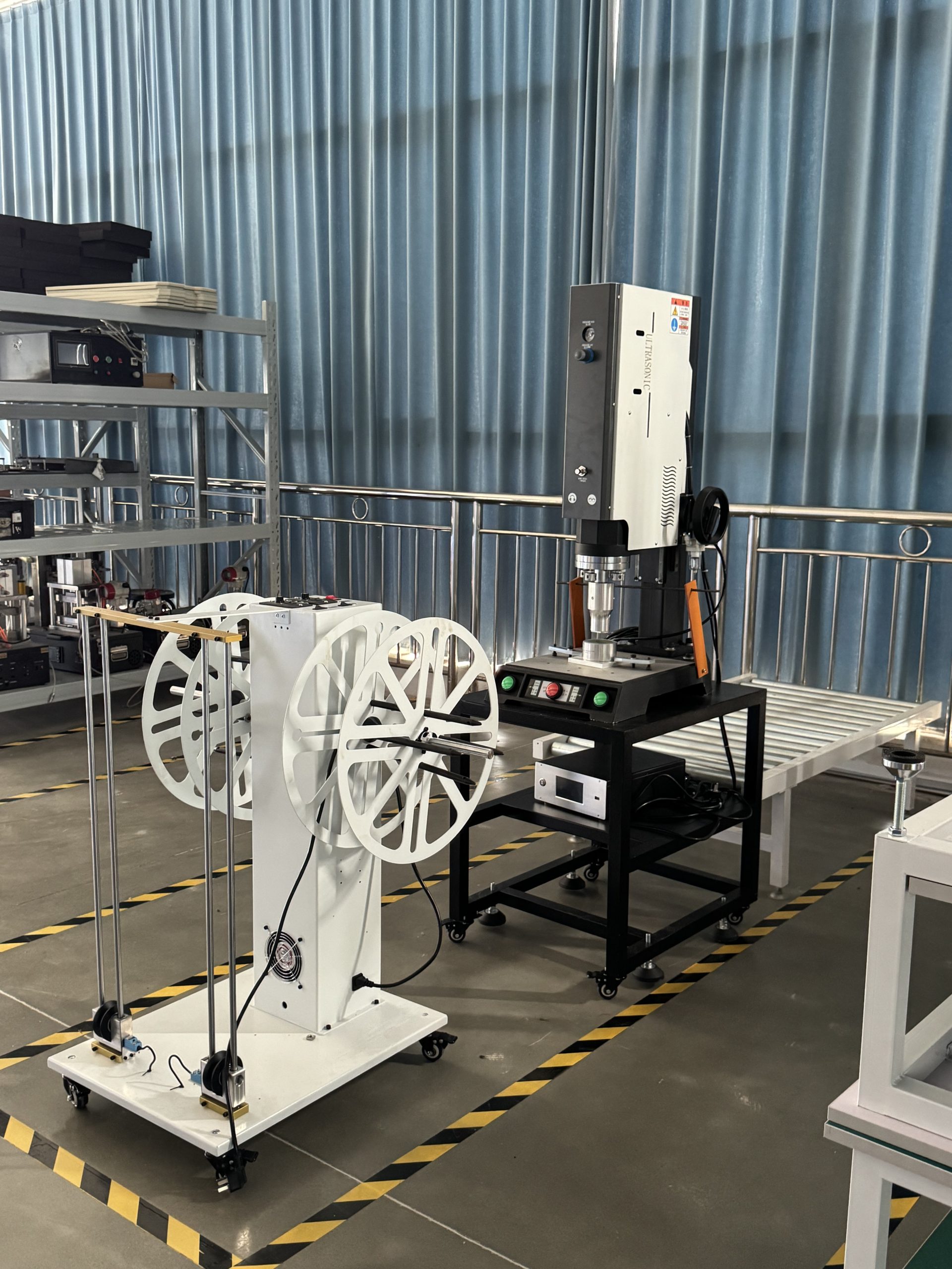 Ultrasonic plastic welding machine and dual-reel take-up pay-off machine at ETENWOLF factory.