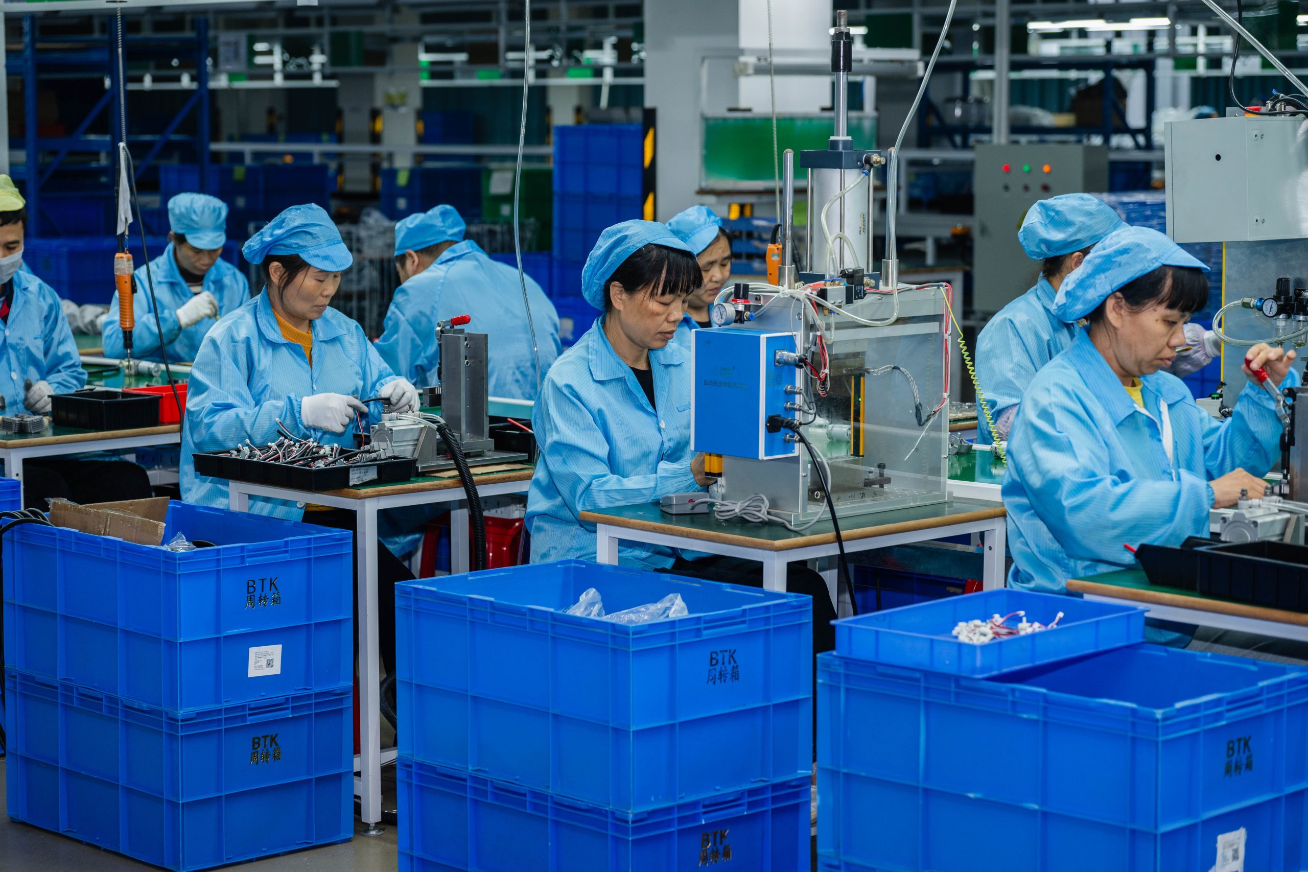 Skilled technicians assembling portable tire inflators on the advanced production line inside ETENWOLF factory.