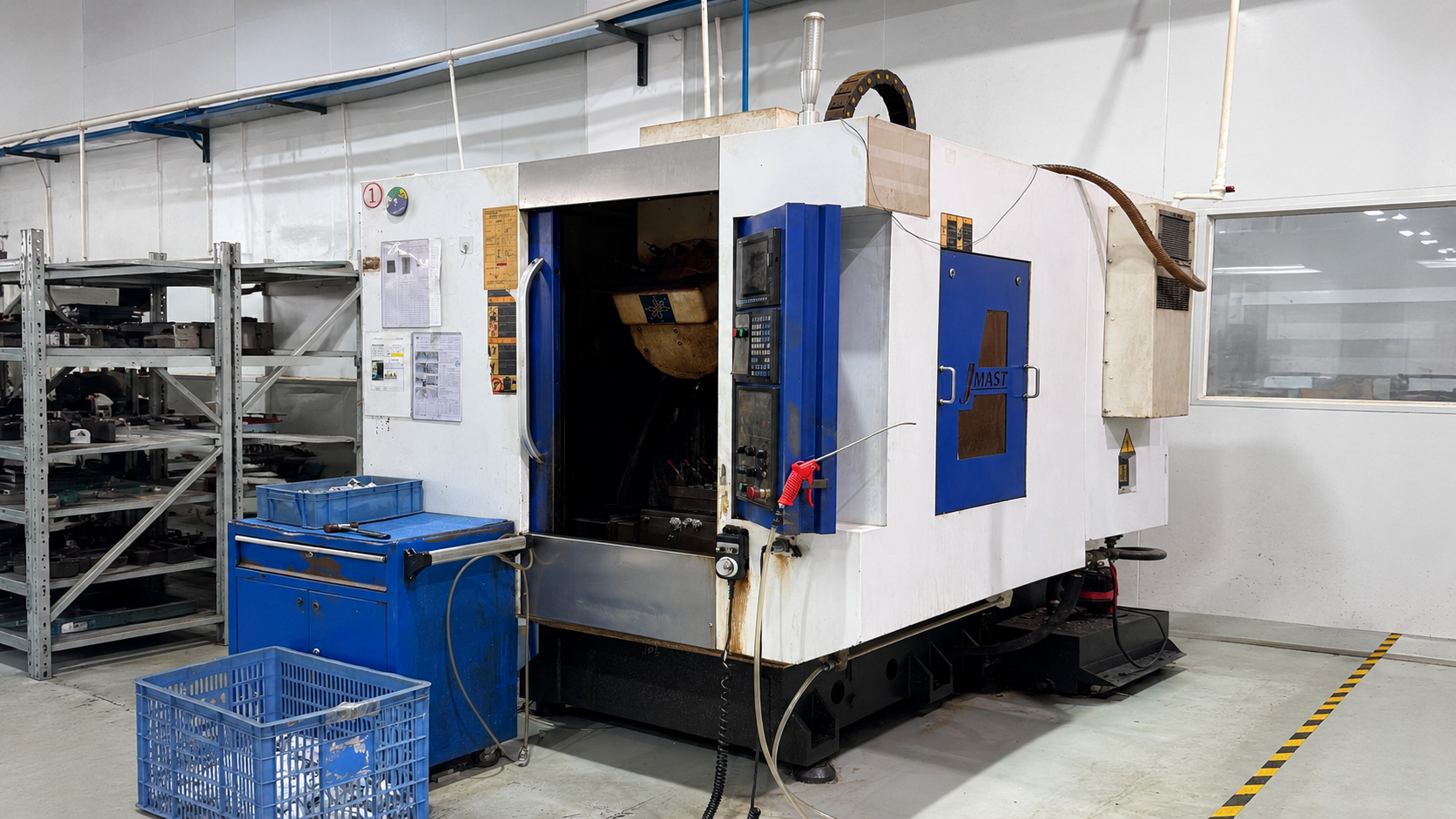 Full view of the blue and white JMAST high-speed CNC engraving and milling machine on the ETENWOLF production floor.