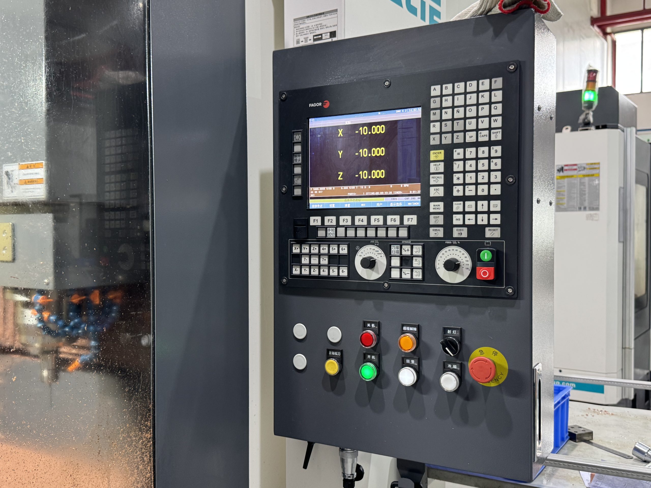 Detailed view of Spain FAGOR CNC control system operating panel and digital display screen.